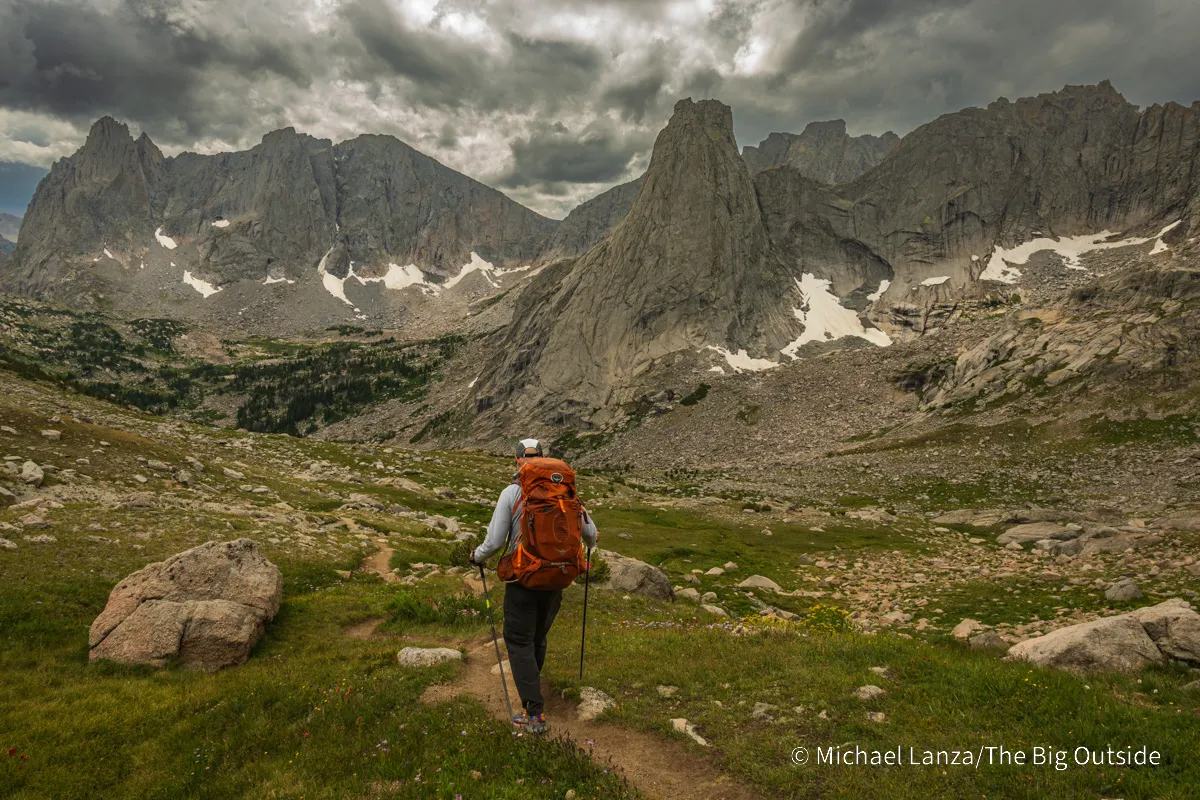 A backpacker descending from Texas Pass into the Cirque of the Towers in the Wind River Range, Wyoming.