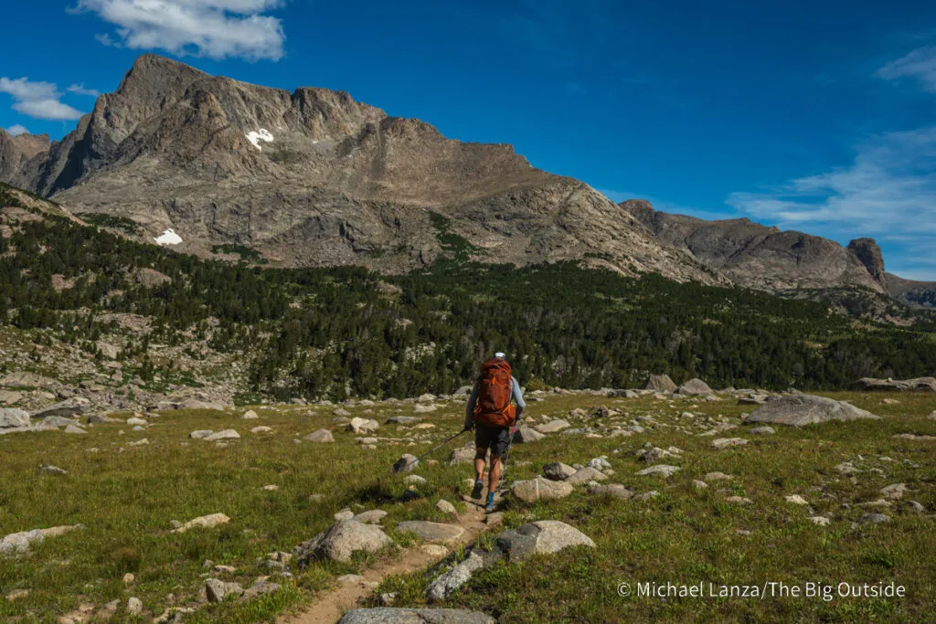 A backpacker hiking north of Hailey Pass in the Wind River Range, Wyoming.
