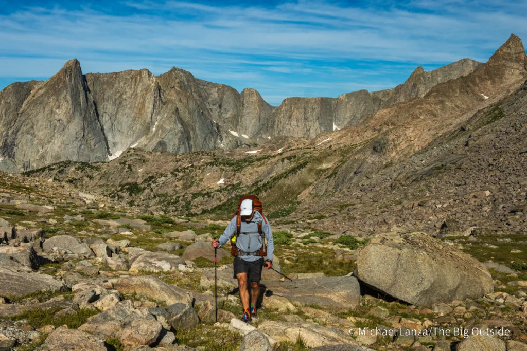 A backpacker hiking the ramp from Pyramid Lake to Hailey Pass in the Wind River Range, Wyoming.