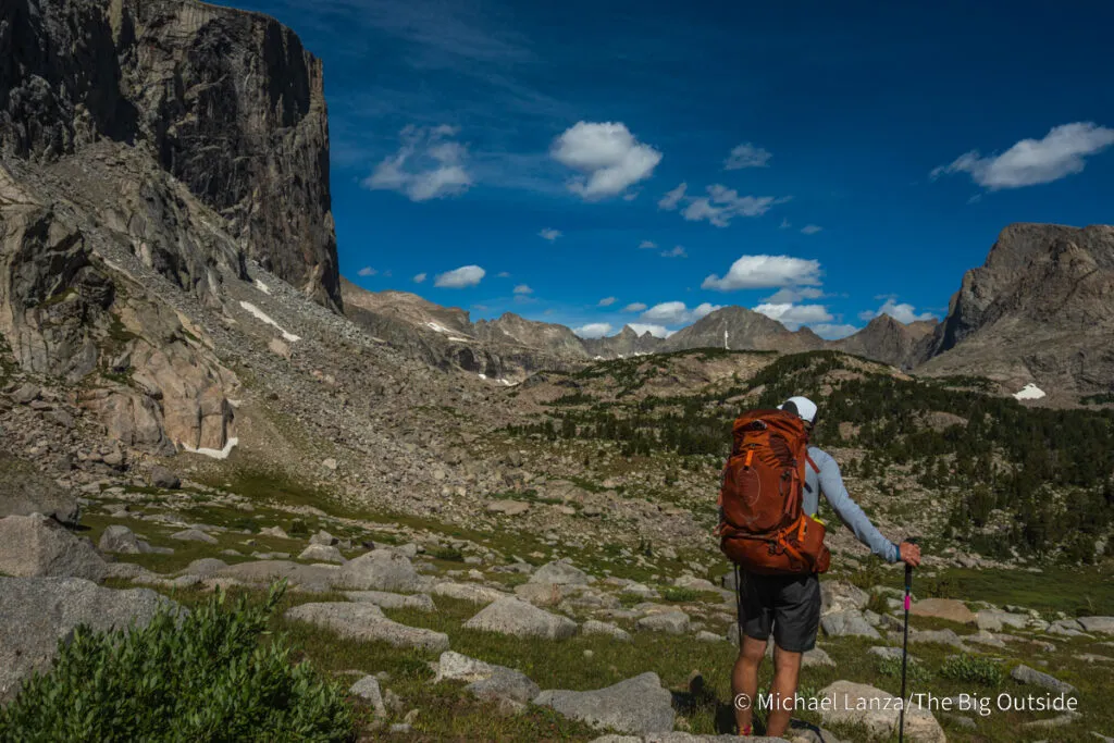 A backpacker looking toward the Baptiste Lake basin in the Wind River Range, Wyoming.
