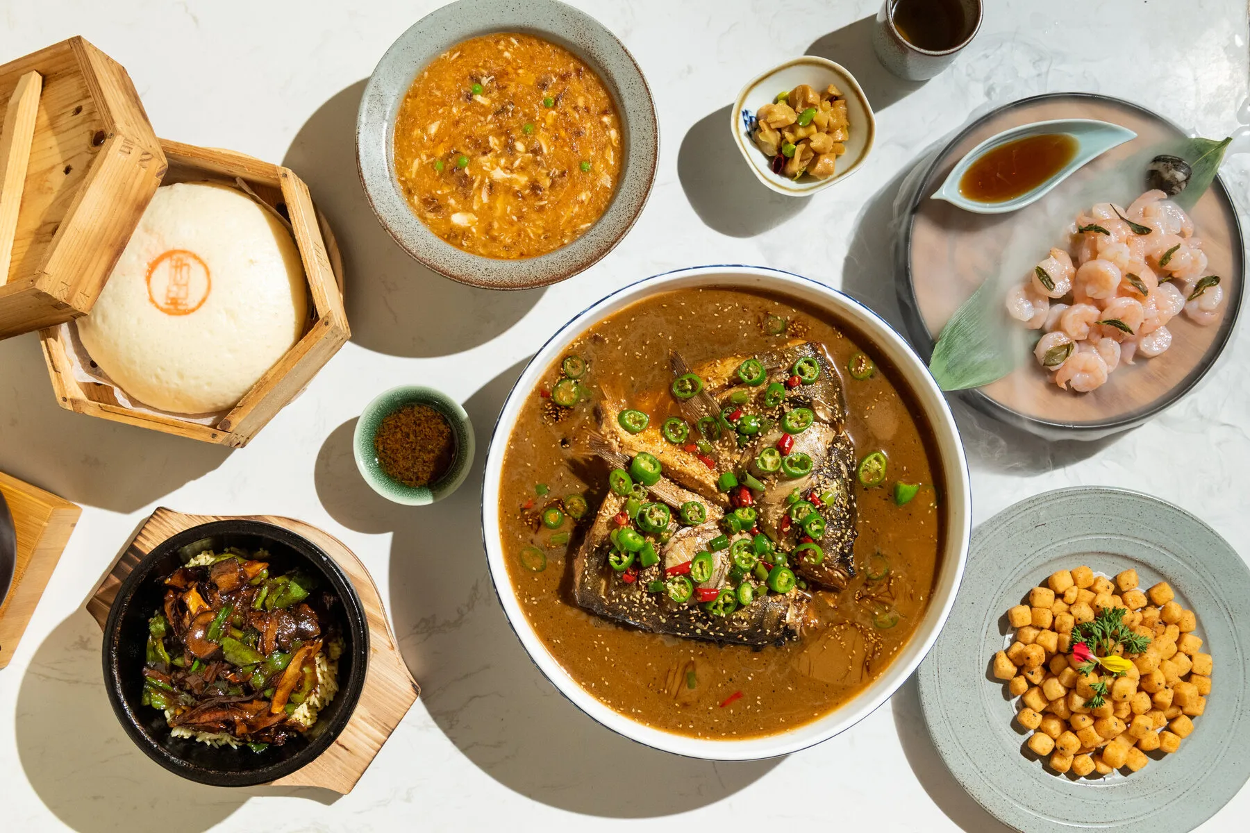 A beautifully arranged platter of Chinese dishes from CheLi, showing intricate details and rich colors.