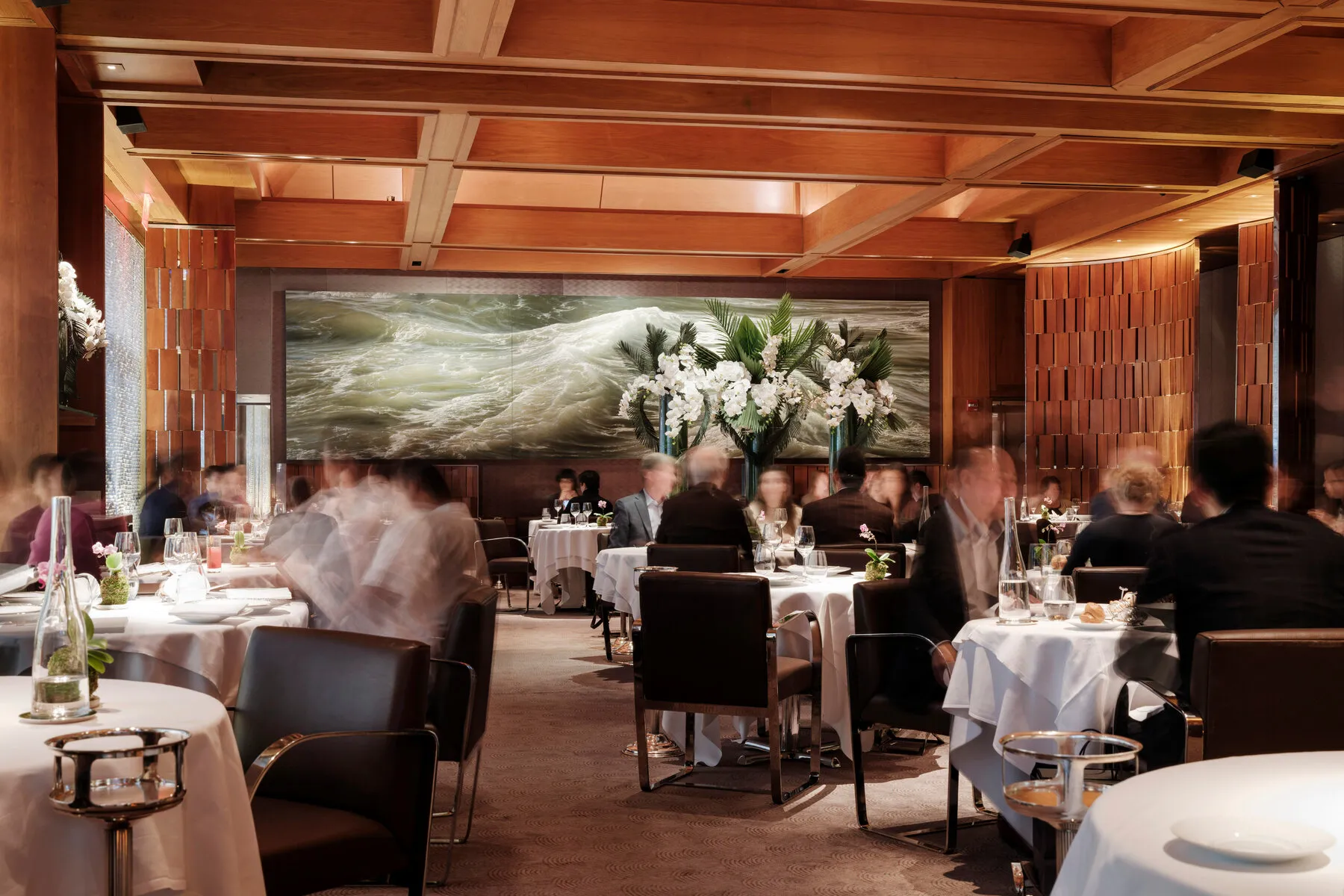 A beautifully presented seafood dish at Le Bernardin, showcasing delicate fish with a rich, colorful sauce, a testament to French culinary artistry.