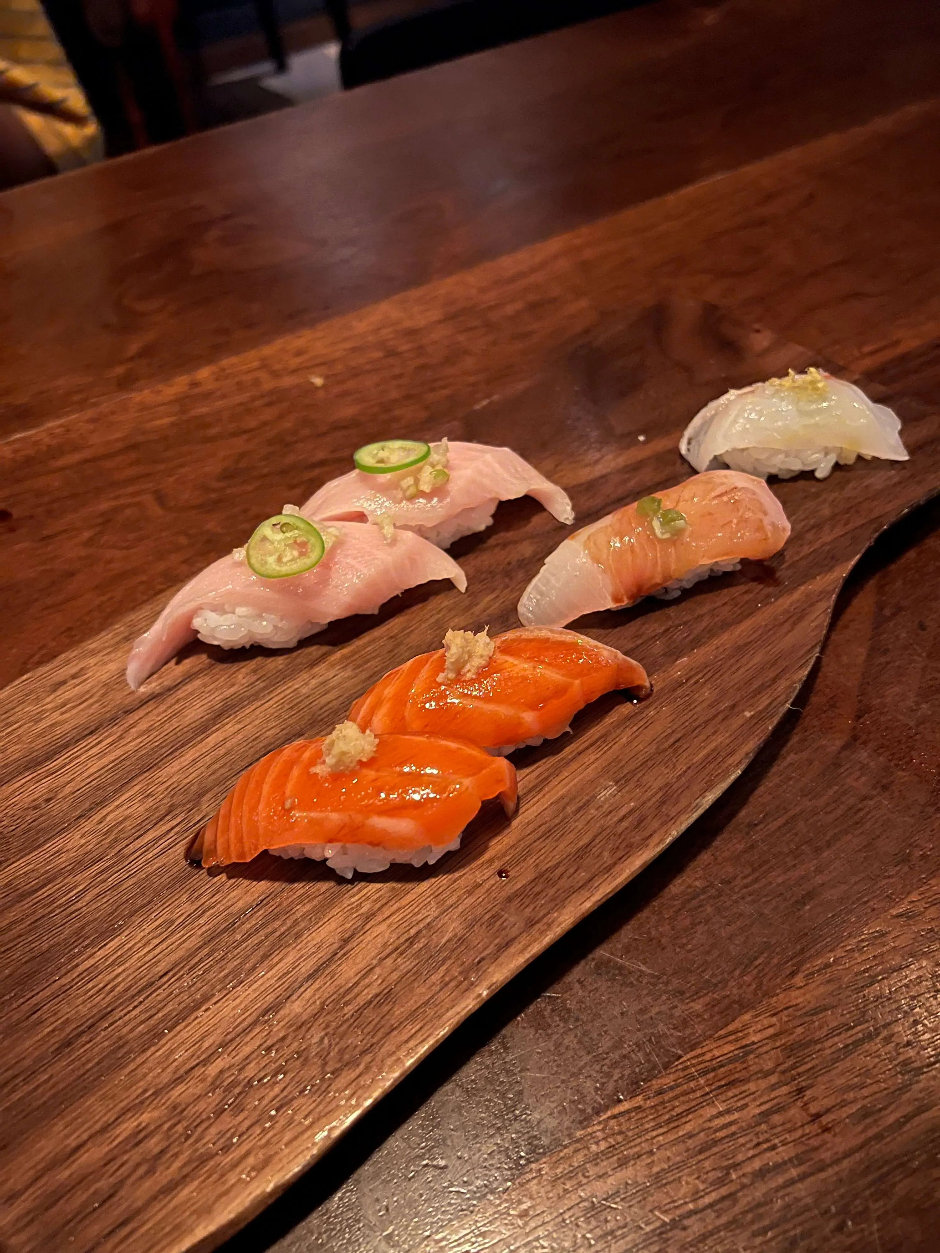 A beautifully presented sushi roll and other dishes at Uchiko Austin