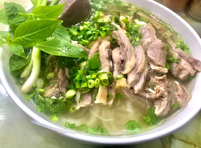 A bowl of Bún Ngang with duck and bamboo shoots, a favored Hanoi Specialty Food for evenings