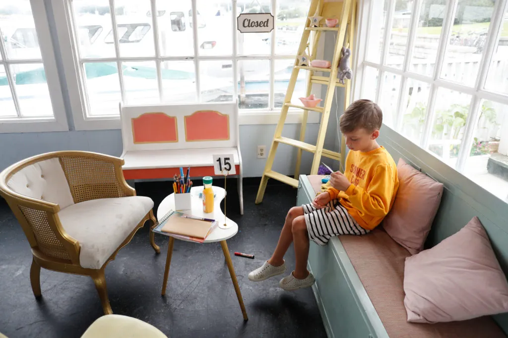 A bright, colorful art cafe with tables and chairs.