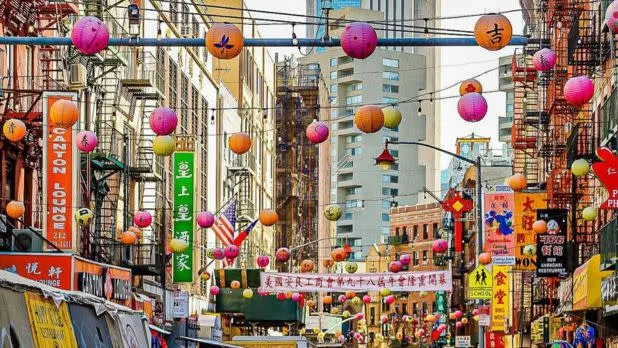 A bustling street scene in Chinatown, one of NYC's vibrant neighborhoods offering free exploration
