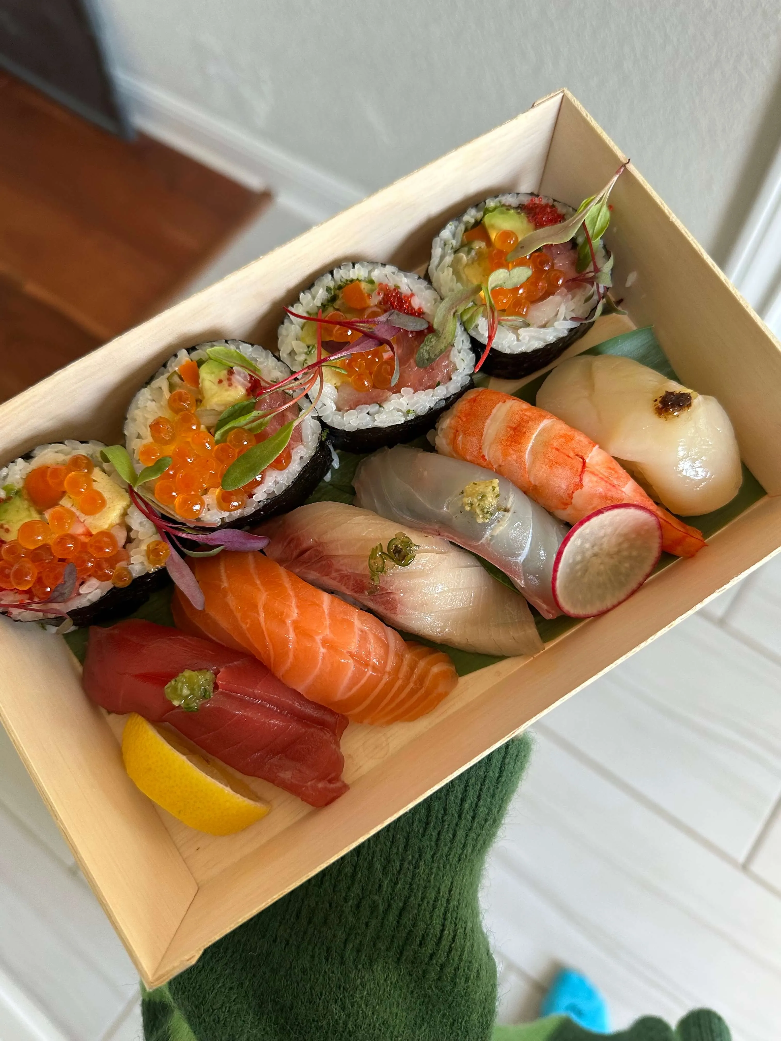 A carefully arranged take-home omakase box featuring a variety of sushi and sashimi by Chef Choo Austin