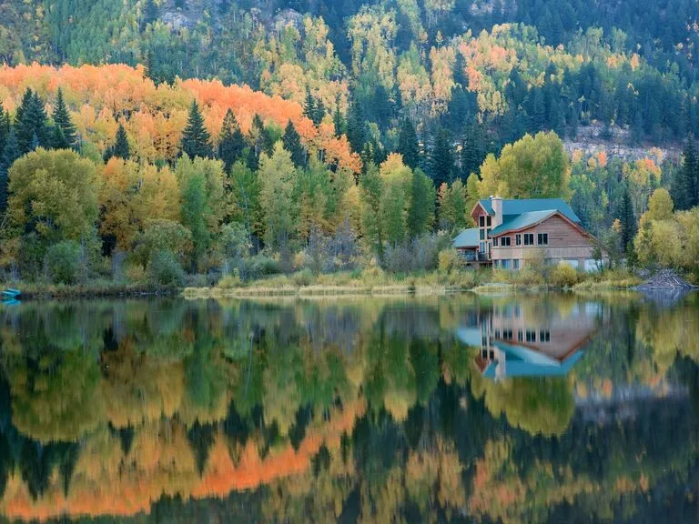 A charming cabin overlooks Lake Purgatory, Colorado, a serene setting for romantic honeymoon destinations.