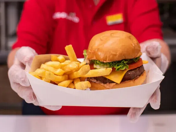 A classic cheeseburger and fries on a tray.