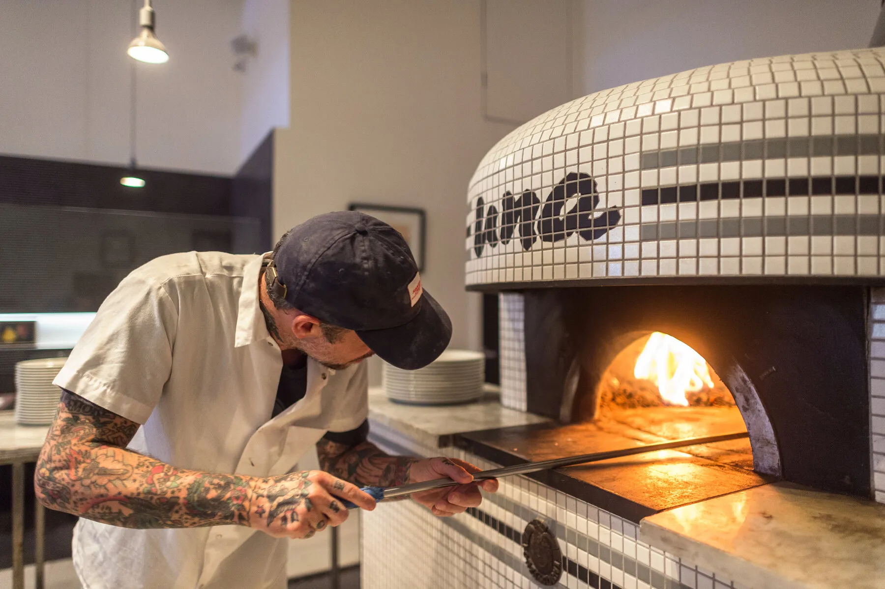 A close-up of a classic Neapolitan pizza from Una Pizza Napoletana, showing the airy crust and simple, fresh toppings.