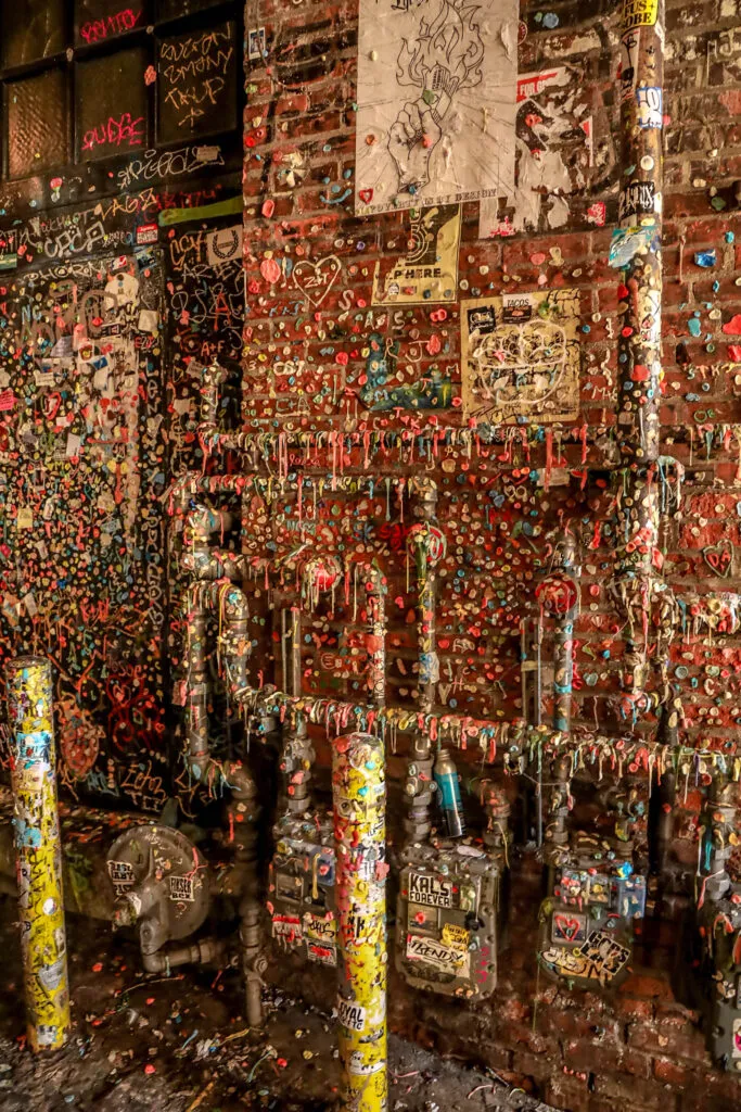 A close-up view of the colorful and textured Gum Wall in Post Alley, Seattle