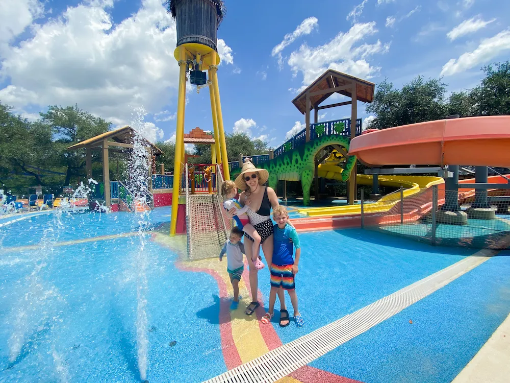 A colorful water park area with slides and splash features