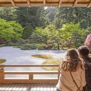 A couple views a serene flat rock garden at the Portland Japanese Garden, a peaceful option for fun things to do in Oregon