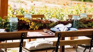 A cozy outdoor dining cabana with a wood stove at Black Cat Farmstead near Denver, suggesting an intimate dining experience.