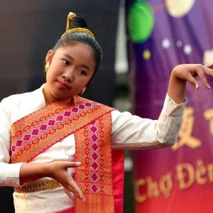 A dancer performing in a colorful sash at the Jade International Night Market