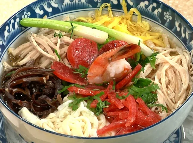 A delicate bowl of Bún Thang with various toppings, a refined Hanoi Specialty Food
