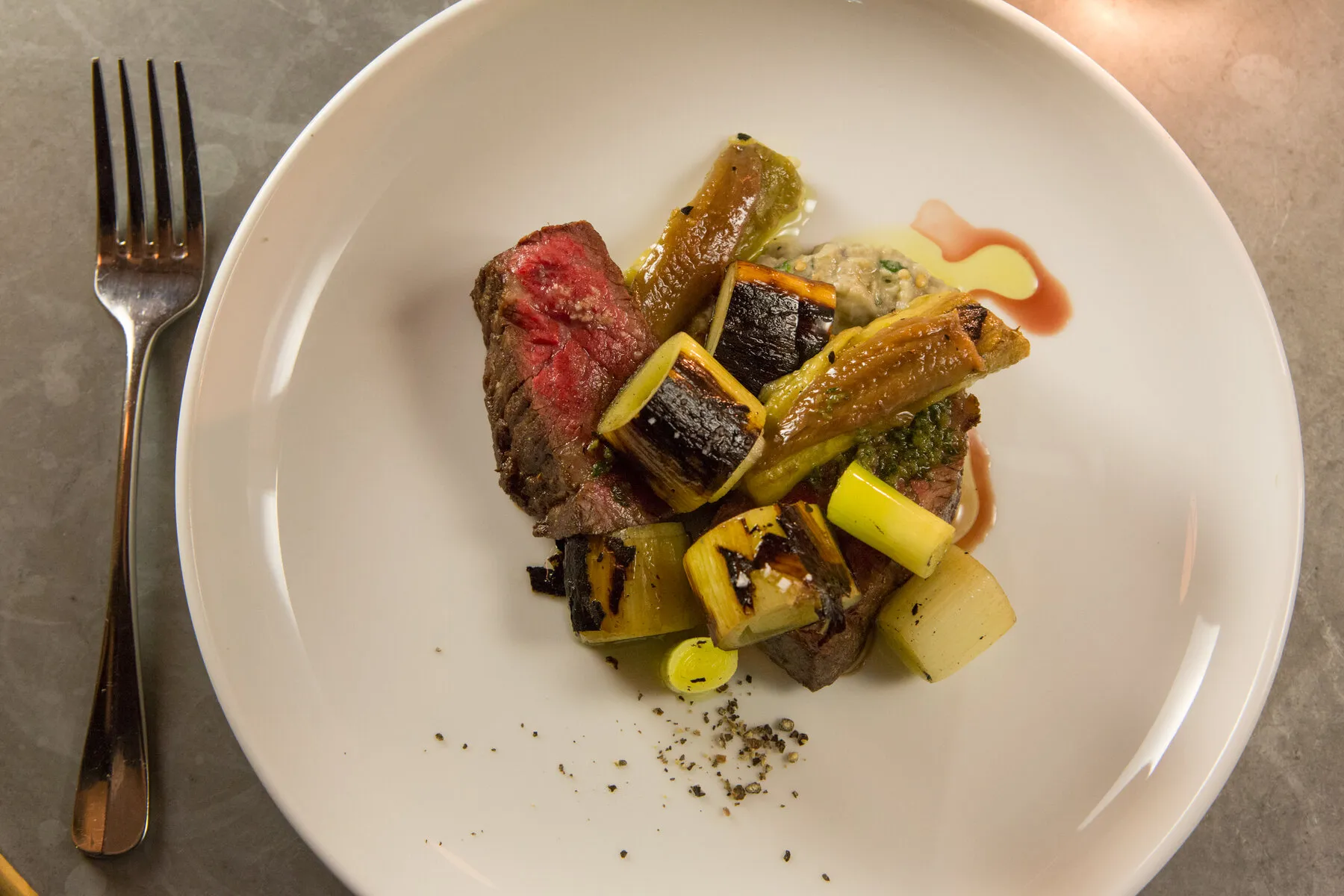 A dish from Estela featuring vibrant ingredients and artistic plating, reflecting the restaurant's innovative approach to New American cuisine.