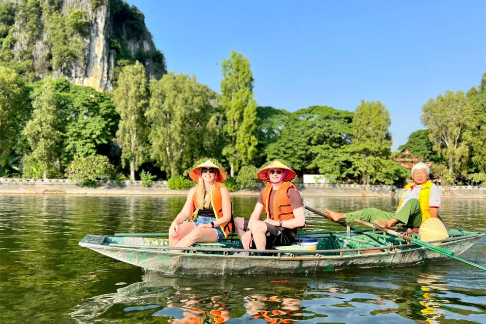 A foot-rowed boat tour through the serene landscape of Ninh Binh, often called Halong Bay on Land