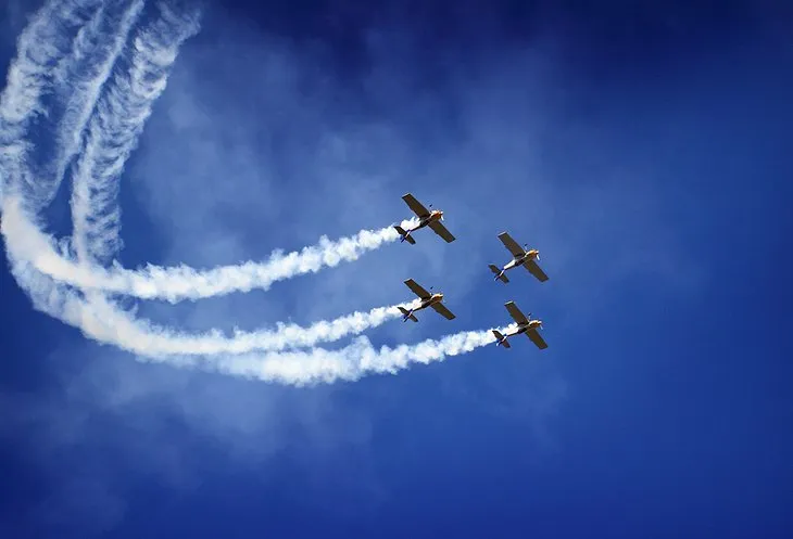 A group of racing airplanes flying closely together during the Reno Air Races