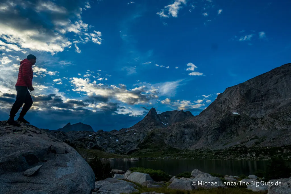A hiker at Pyramid Lake in the Wind River Range, Wyoming.
