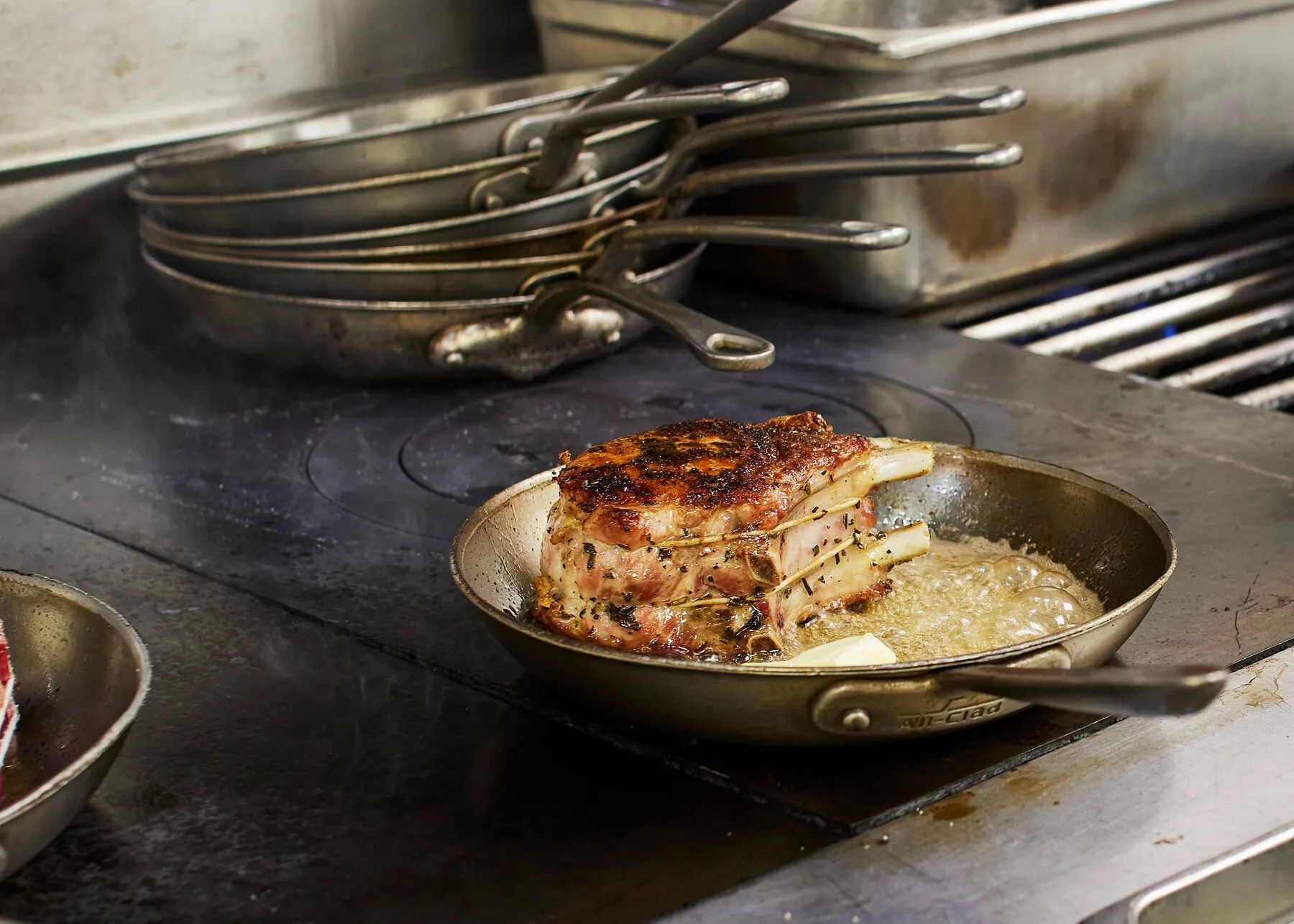 A main course dish from Craft, served family-style in a copper pan.