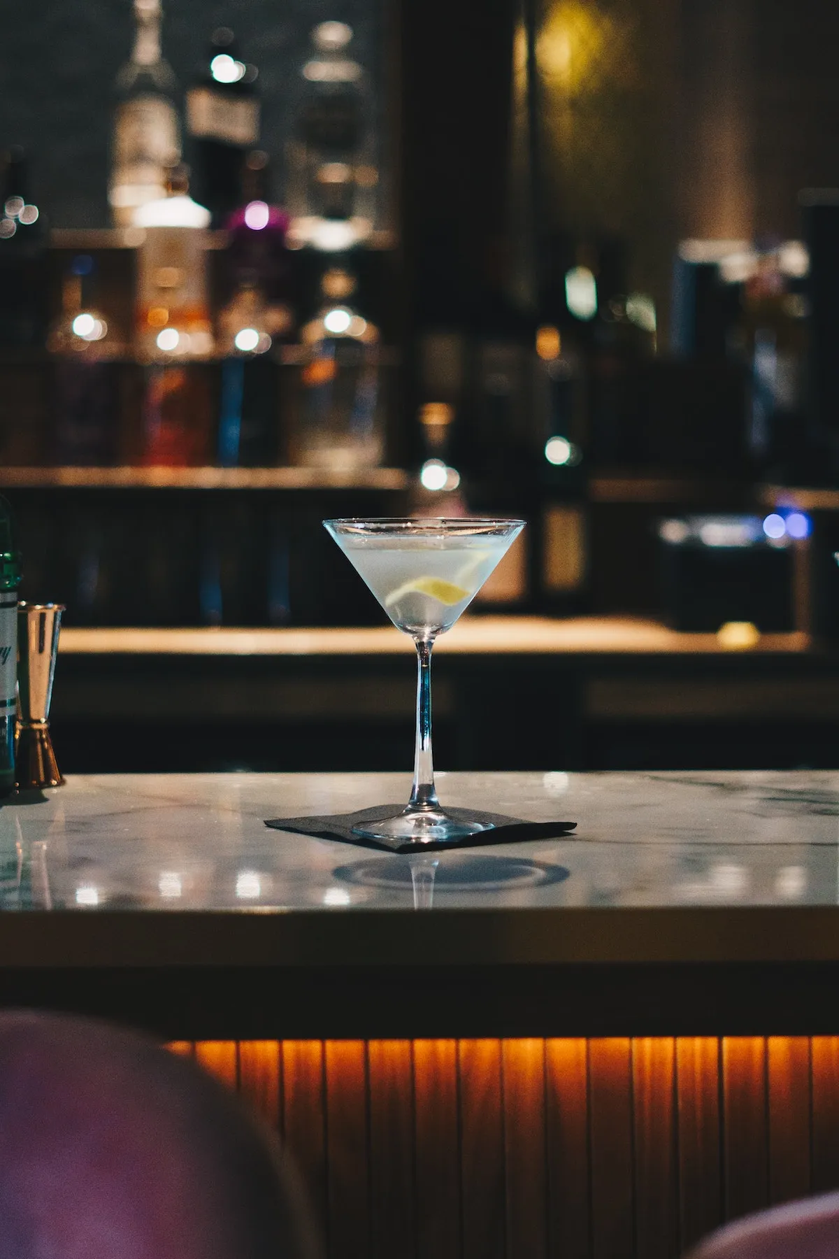 A martini on a bar top in a themed New York bar, showcasing the variety of experiences when going out in new york.