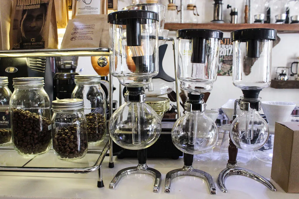 A minimalist cafe interior with customers enjoying coffee