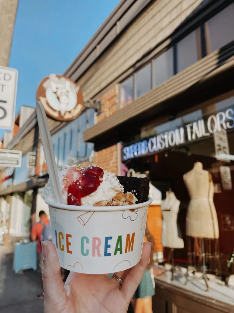 A person holding a cup of ice cream from Molly Moon's, a popular local spot in Seattle