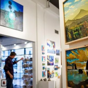 A person walking through an art gallery in the Alberta Arts District, Portland
