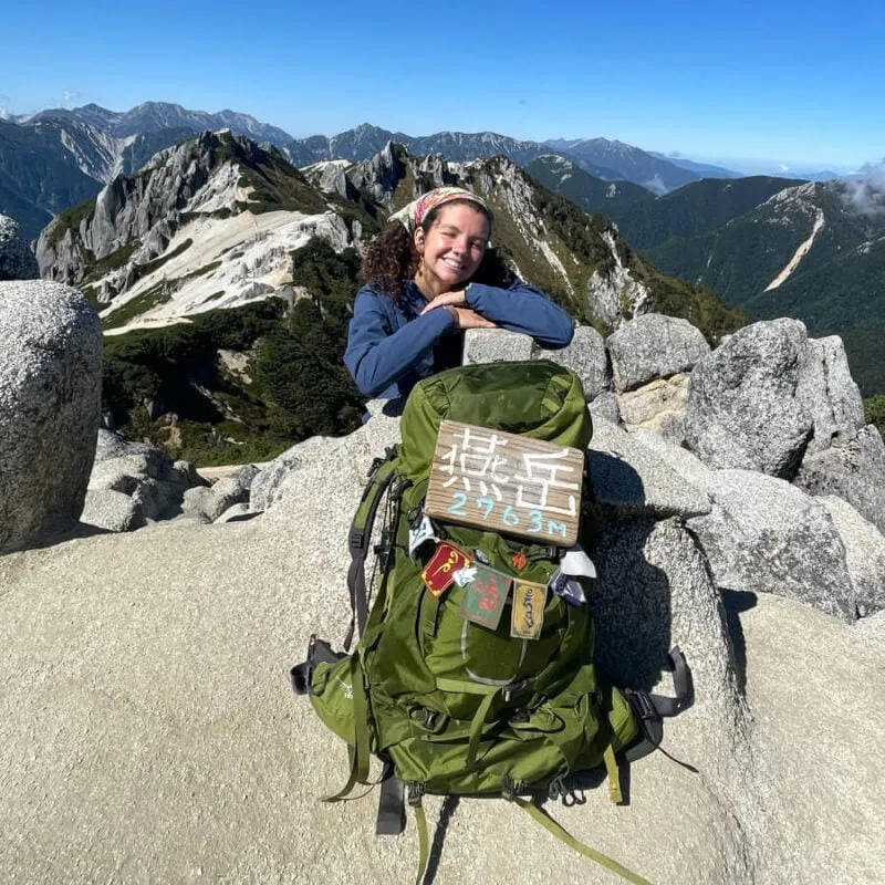 A person wearing a backpack on a hiking trail.