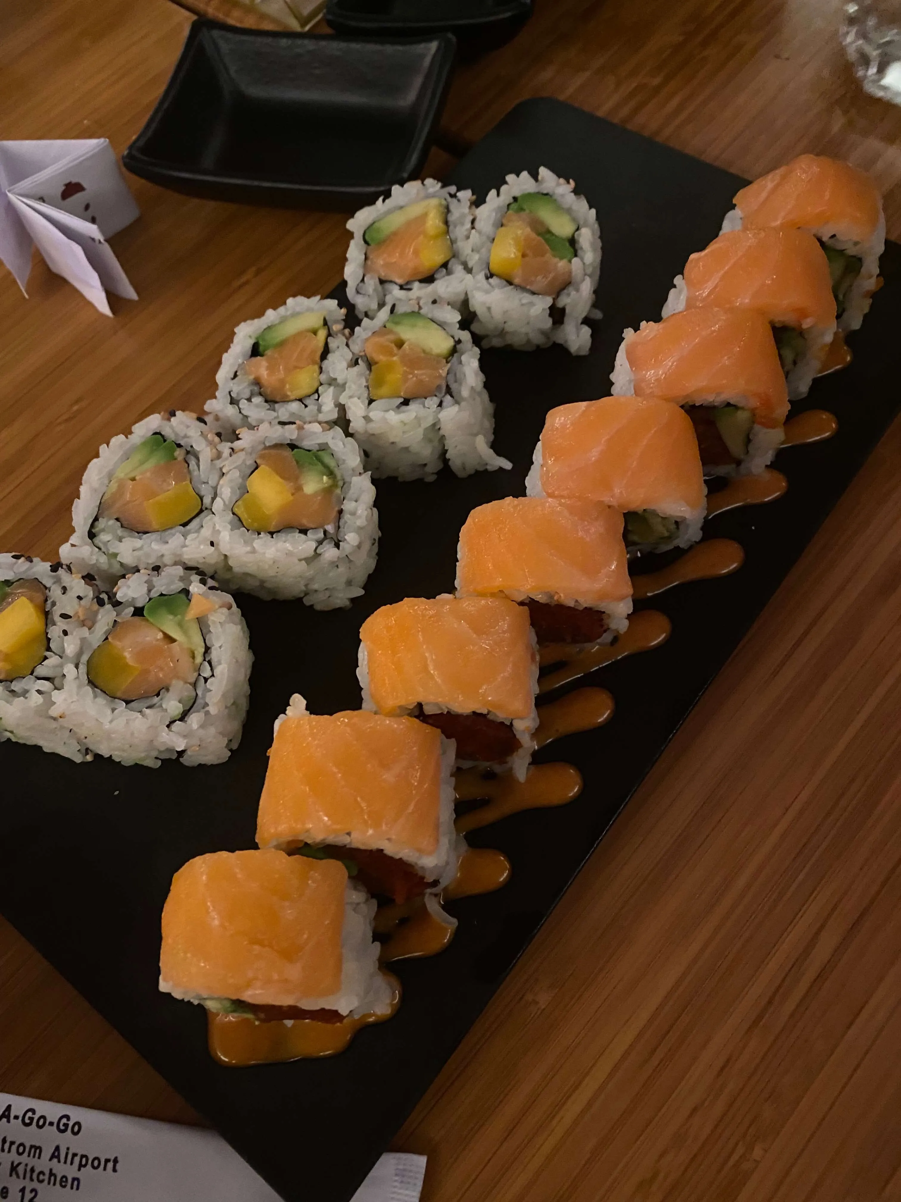 A plate featuring a selection of colorful and creatively named sushi rolls at Kome Austin