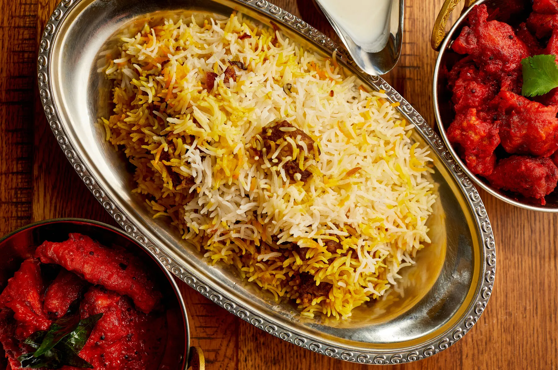 A plate of Hyderabadi biryani, showing the rice and meat preparation.