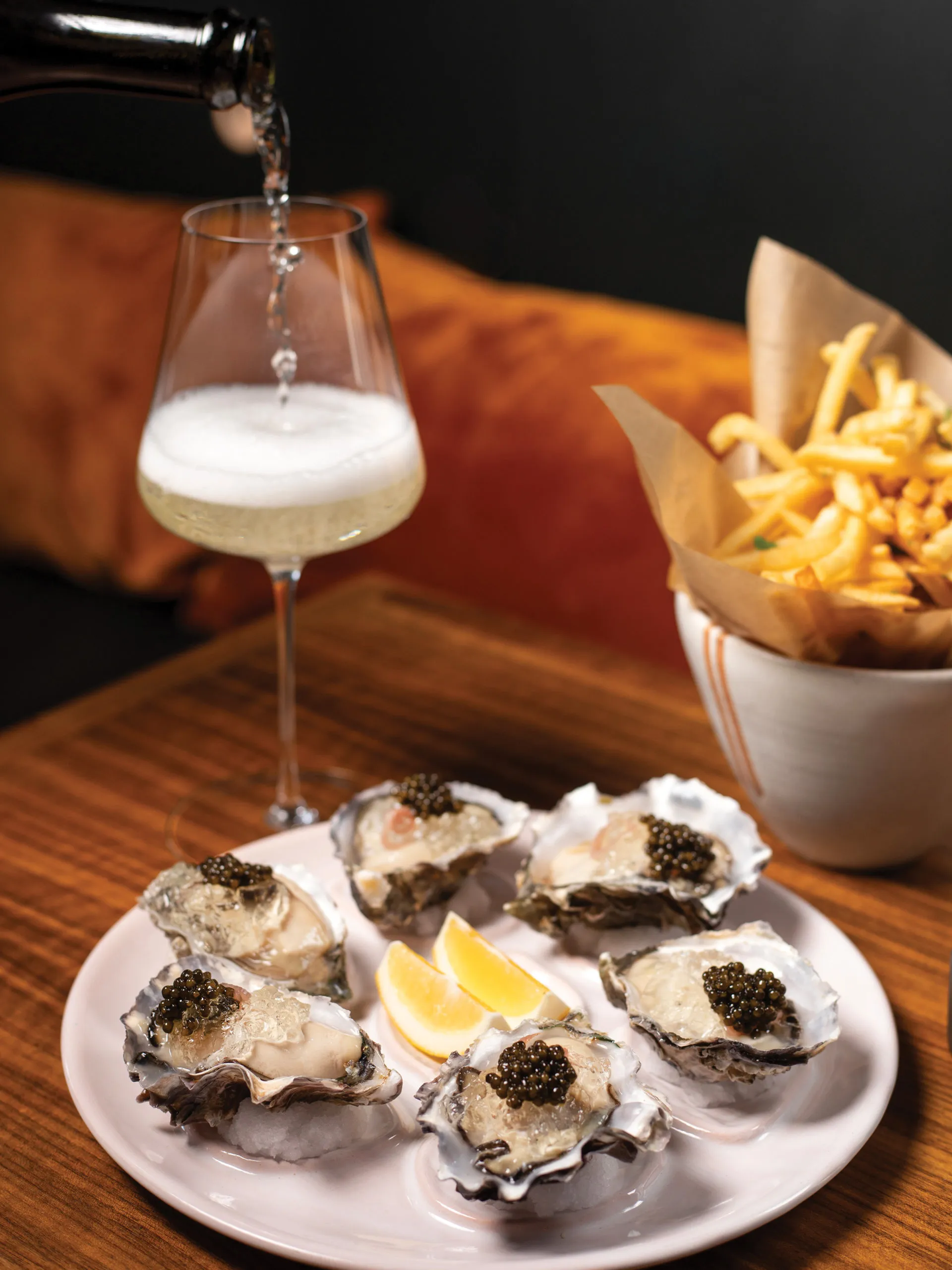 A plate of oysters is presented with garnishes.