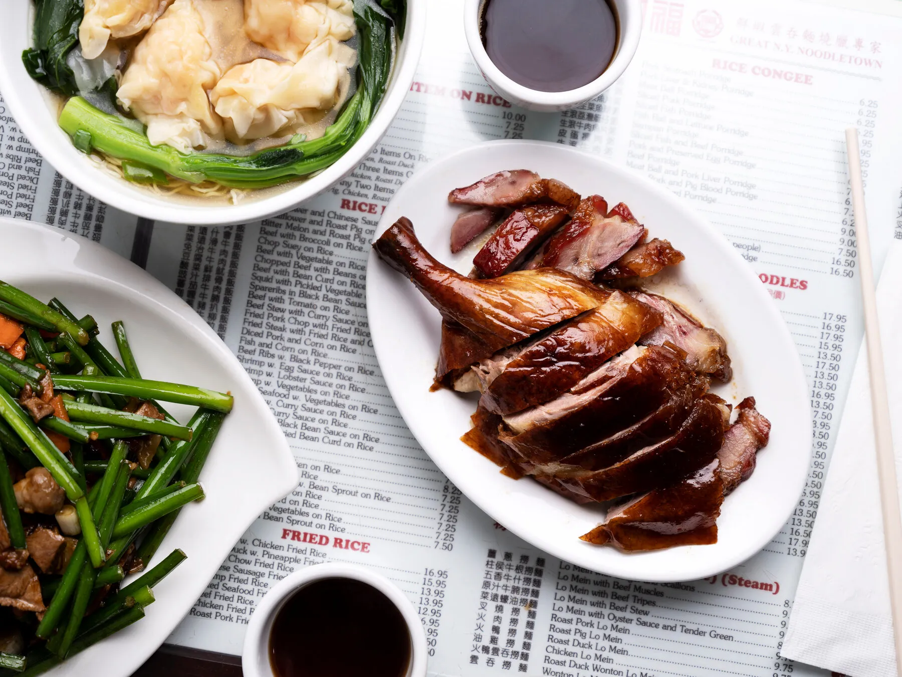 A plate of roast duck or meat from Great N.Y. Noodletown, showing the crispy skin and juicy meat.