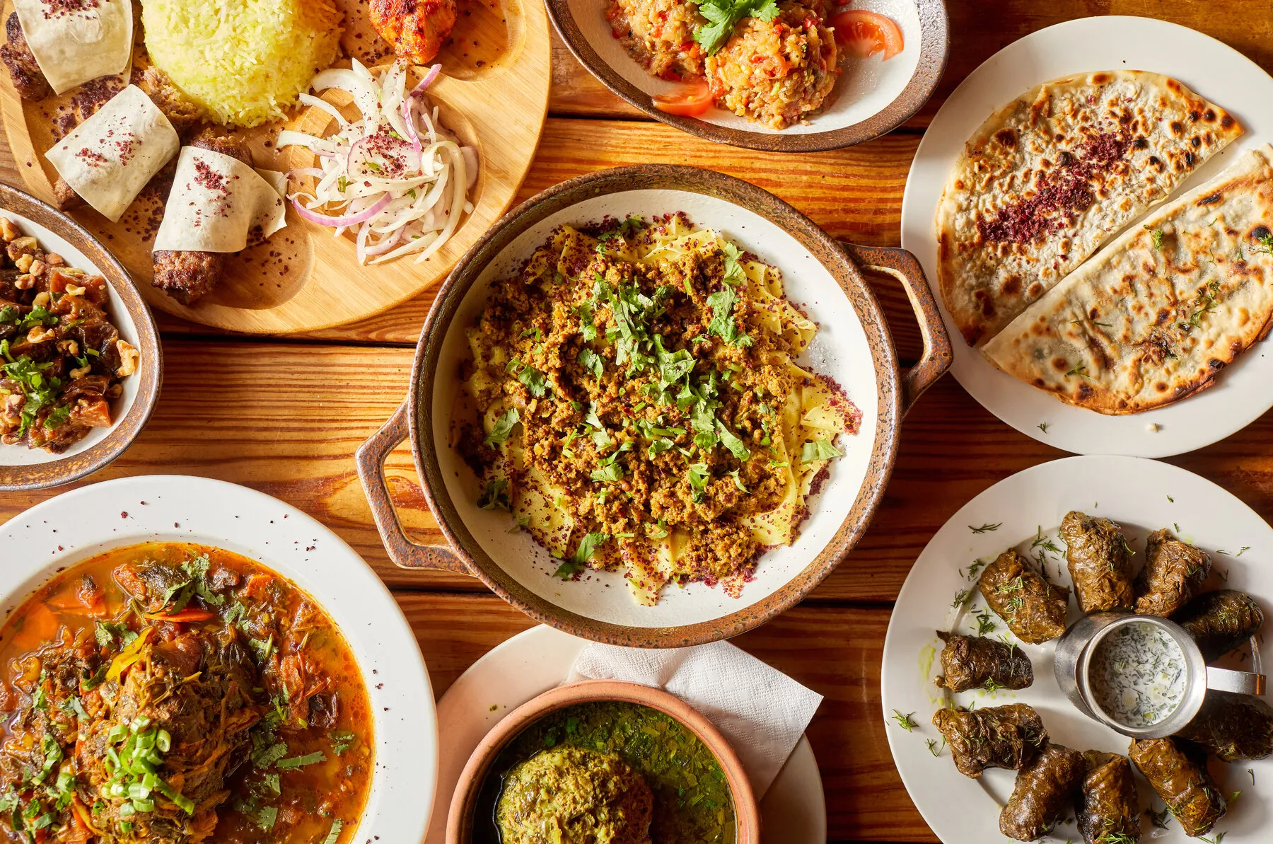 A platter of Azerbaijani kebabs and rice from Village Cafe, showcasing the restaurant's grilled meat offerings.