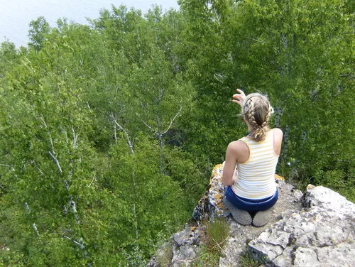 A scenic cliff overlook on Drummond Island, Michigan, offering expansive views for hikers exploring the island's rugged trails.