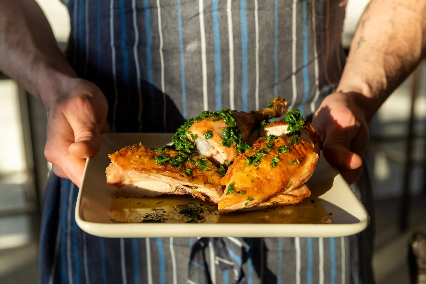 A signature roasted chicken dish from Barbuto, served in a pan with salsa verde.