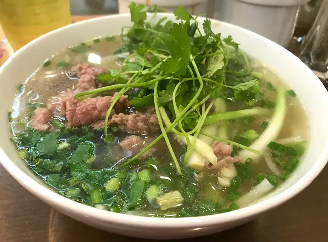 A steaming bowl of Phở Bò, a quintessential Hanoi Specialty Food