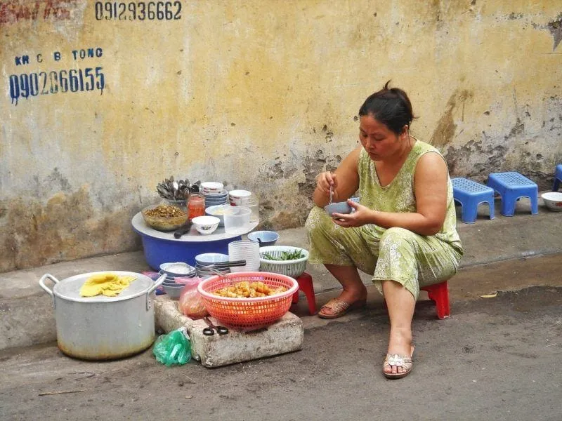 A street food stall in Hanoi serving traditional Vietnamese dishes, a popular culinary experience