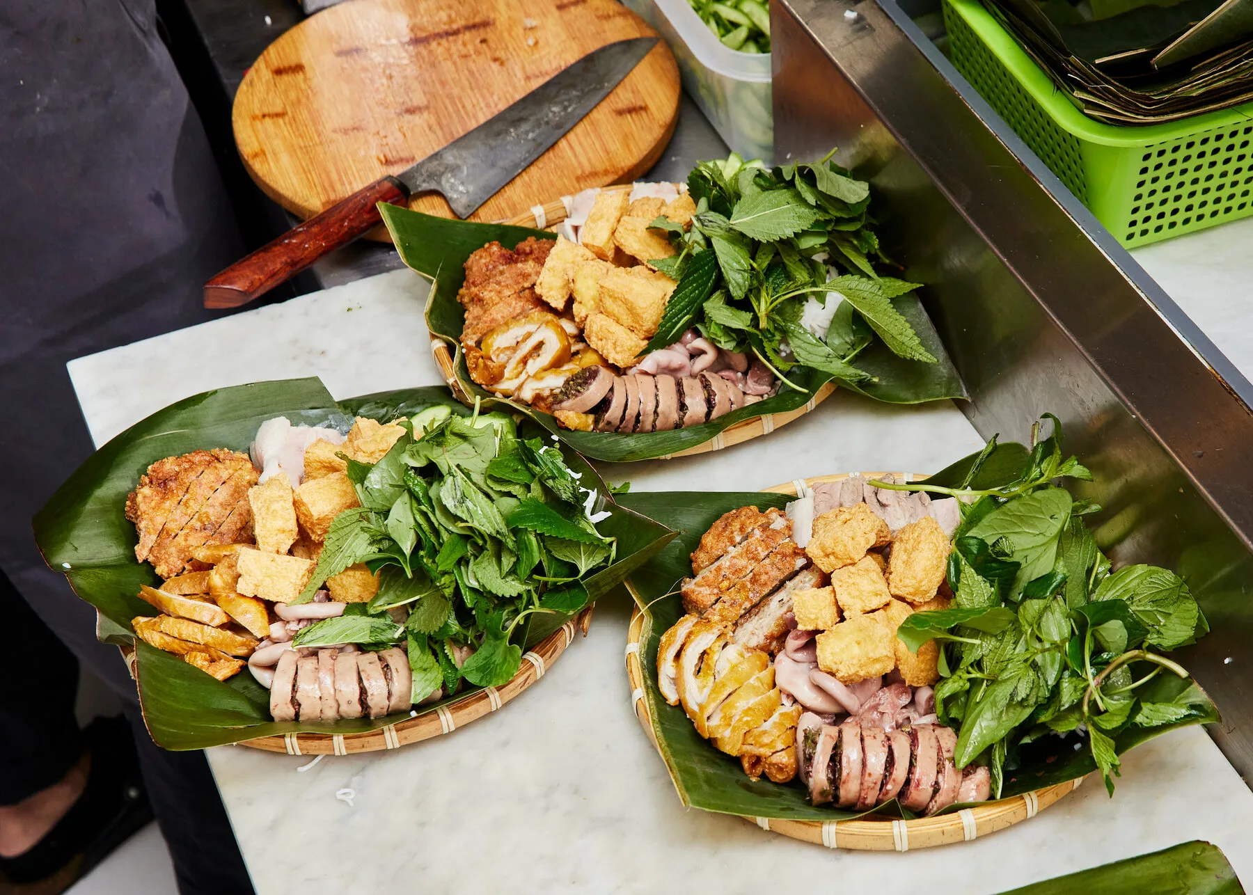 A table laden with Vietnamese dishes at Mam, including bun dau mam tom, showcasing the variety of components.