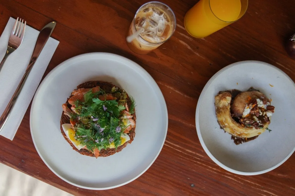 A table setting in the sunny courtyard of Stationaery, showing food and drinks, capturing the cafe's hip vibe.