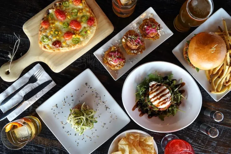 A table spread with dishes from Atmosphere Gastropub, one of the best restaurants in Colorado Springs.