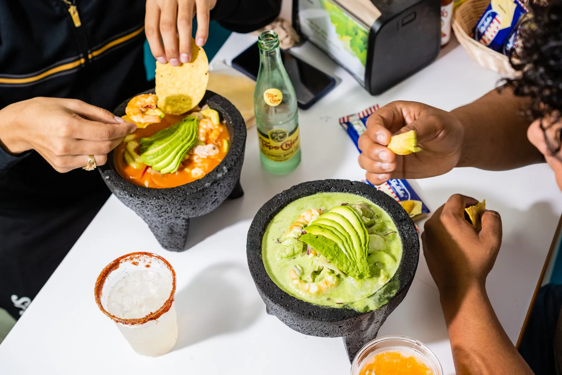 A vibrant seafood cocktail or aguachile served in a plastic cup from Mariscos El Submarino.