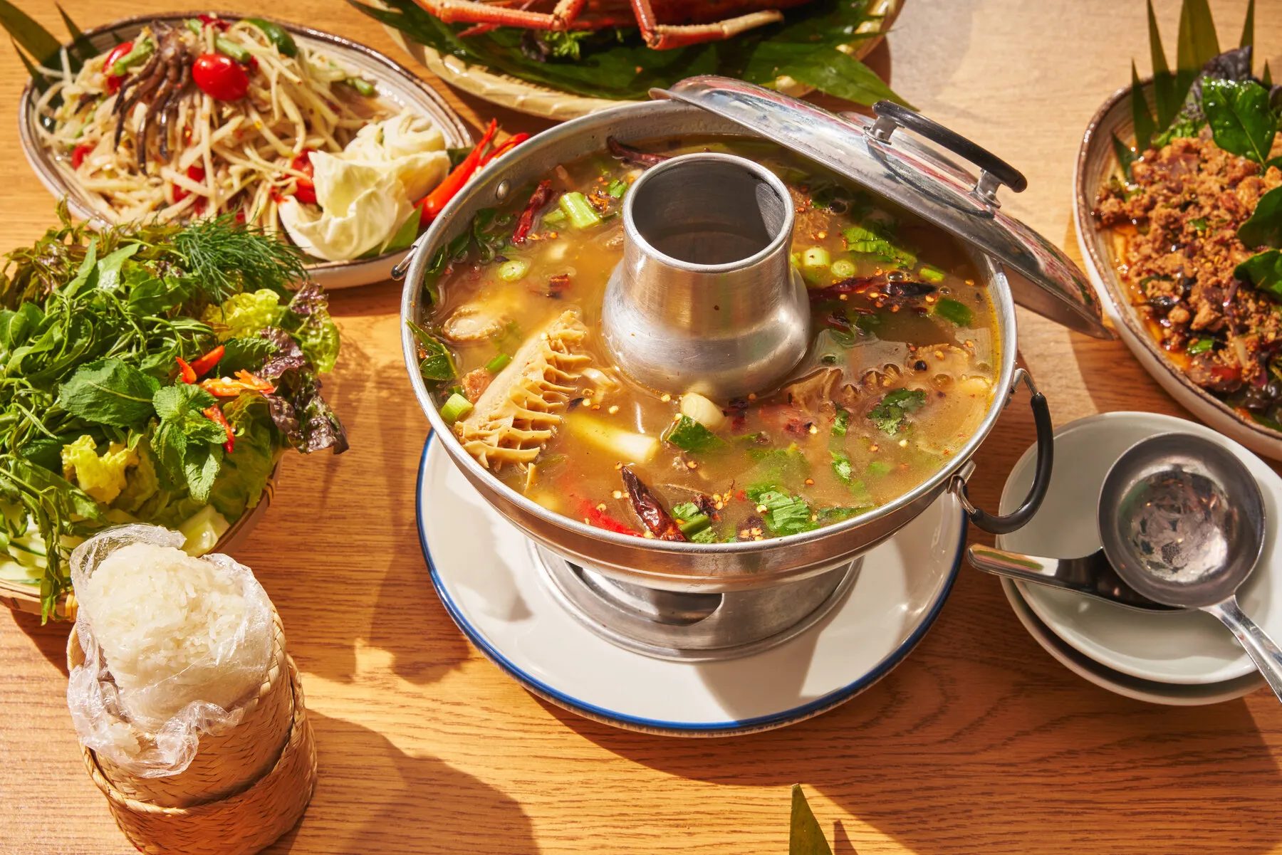 A vibrant Thai dish featuring seafood and herbs from Zaab Zaab, illustrating the restaurant's focus on Isan flavors.