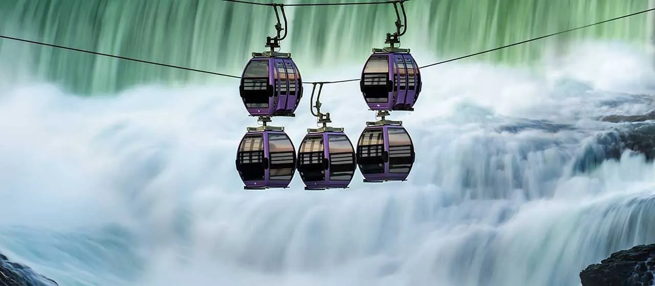 A view of the Spokane Riverfront Park and SkyRide cabins over the falls