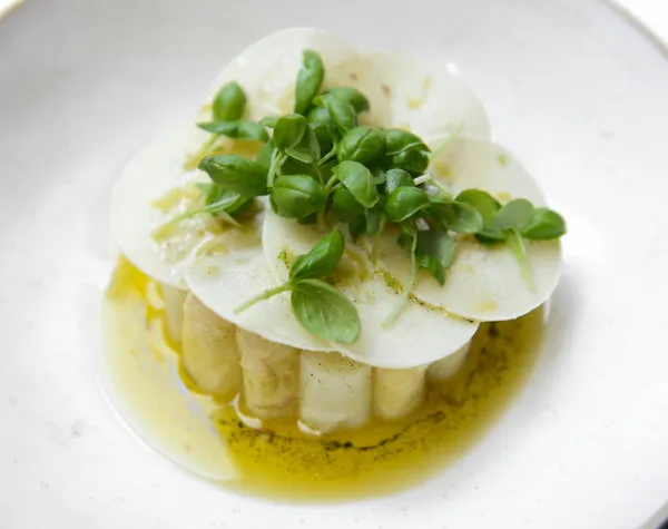 A visually appealing vegetarian dish from ABCV, featuring vibrant vegetables and thoughtful presentation.