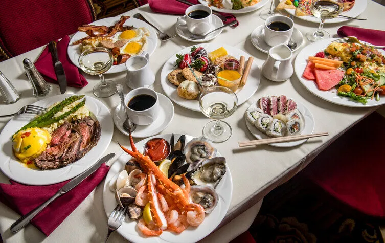 alt text: A table laden with delicious food at The Queen Mary, showcasing the culinary experiences available at this Los Angeles tourist attraction.
