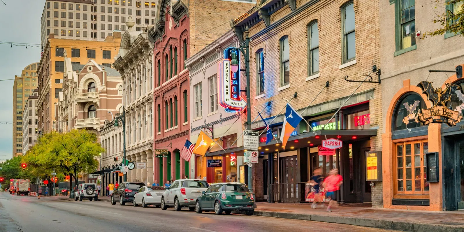 Discover the Best of the Bayou City - Your Guide to Houston City Tours Alt text: A vibrant street scene in Austin, Texas, with colorful buildings, outdoor seating, and people walking, capturing the city's lively atmosphere.