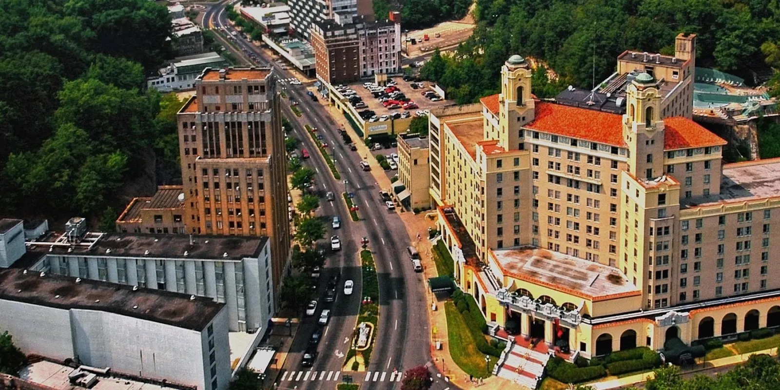 Alt text: Historic Bathhouse Row in Hot Springs National Park, Arkansas, showing ornate early 20th-century buildings lining a street with trees.