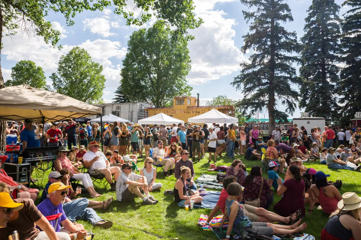 Alt text of people enjoying a craft beer festival outdoors with tents and crowd